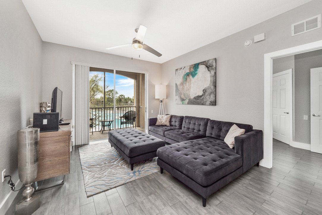 Living room opening onto the pool-view balcony